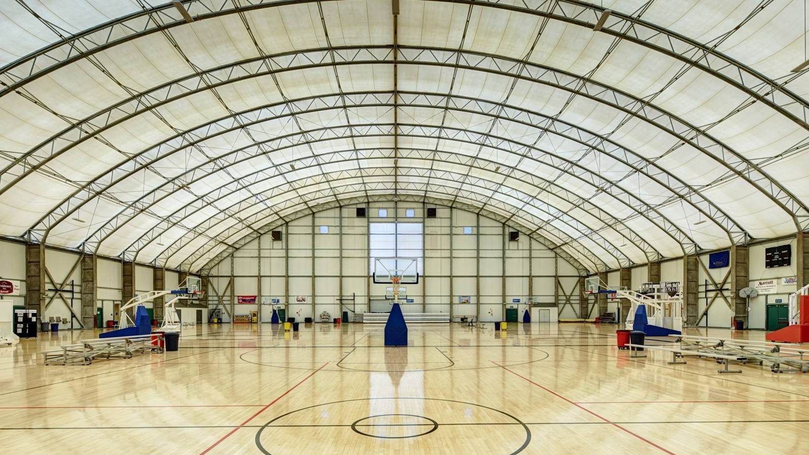 The main gym at Sol City SportsCenter — six basketball courts and a main court under one 200-foot clear-span roof